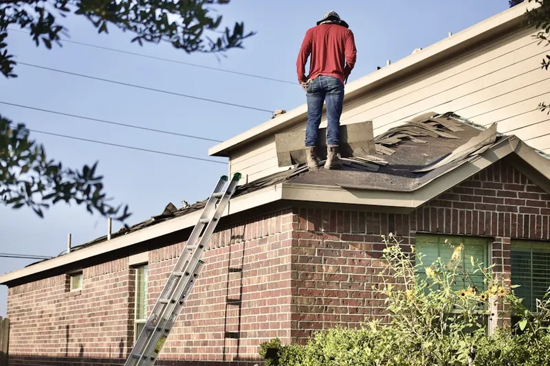 Professional roofer working on a residential roof in Ione